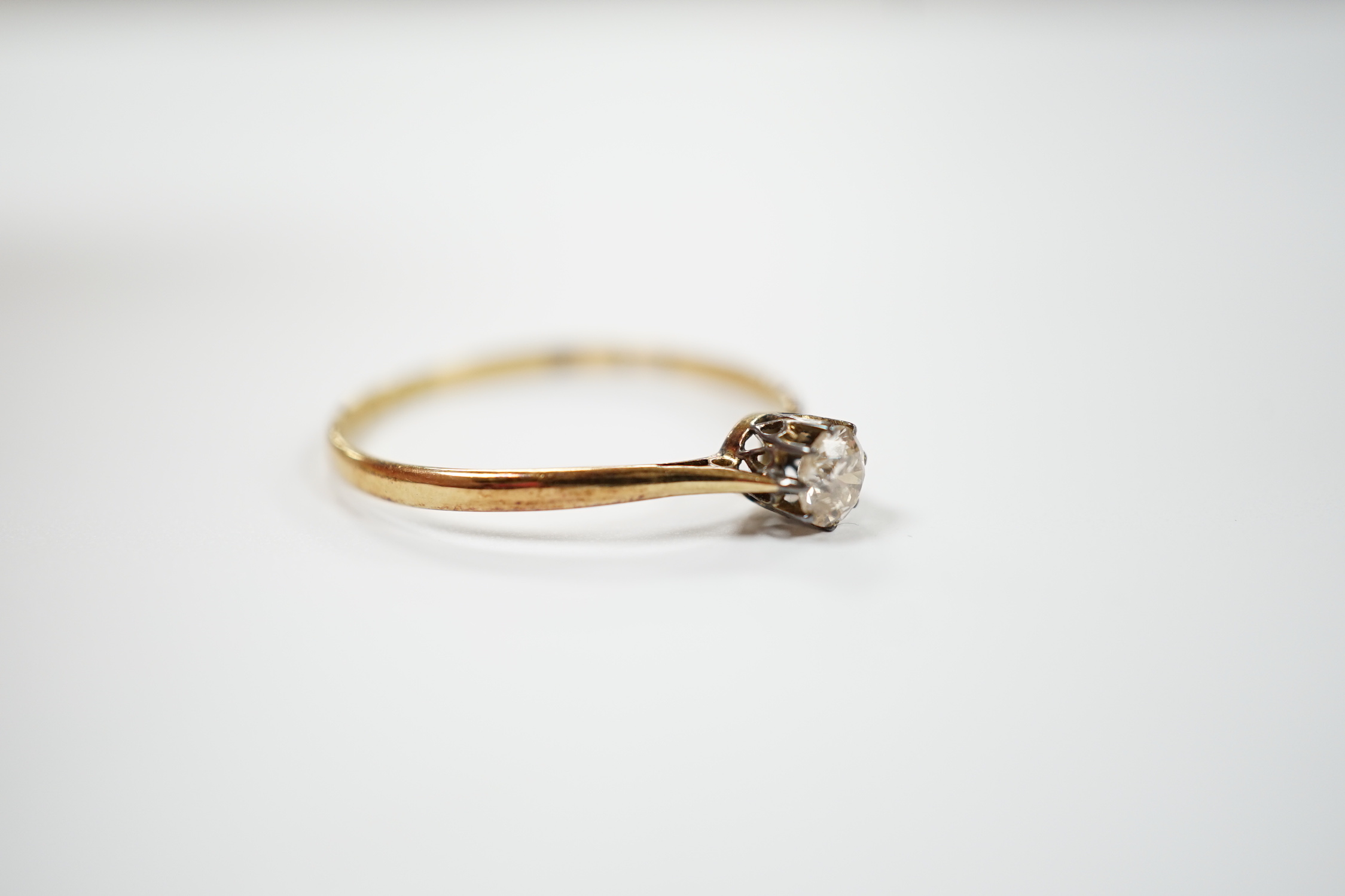 A 1920's 18ct gold and solitaire diamond set ring, size V, gross weight 1.8 grams.